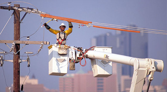 An Oncor team member working on a transmission line