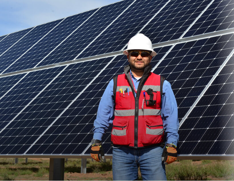 A Sempra Infrastructure employee working at a solar panel facility