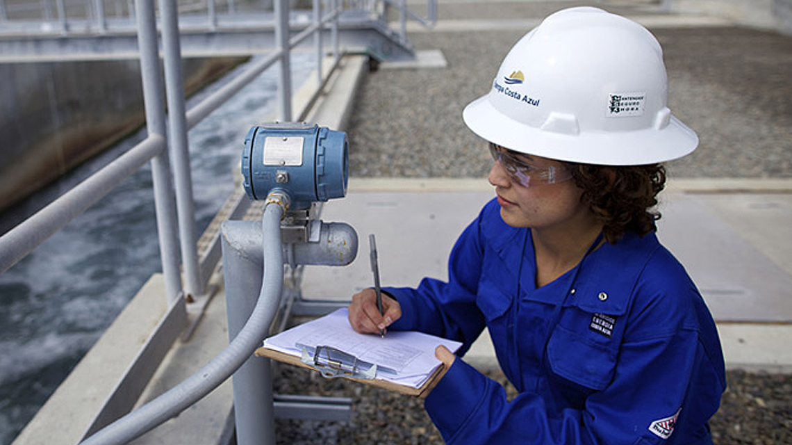 An ECA LNG team member checks equipment
