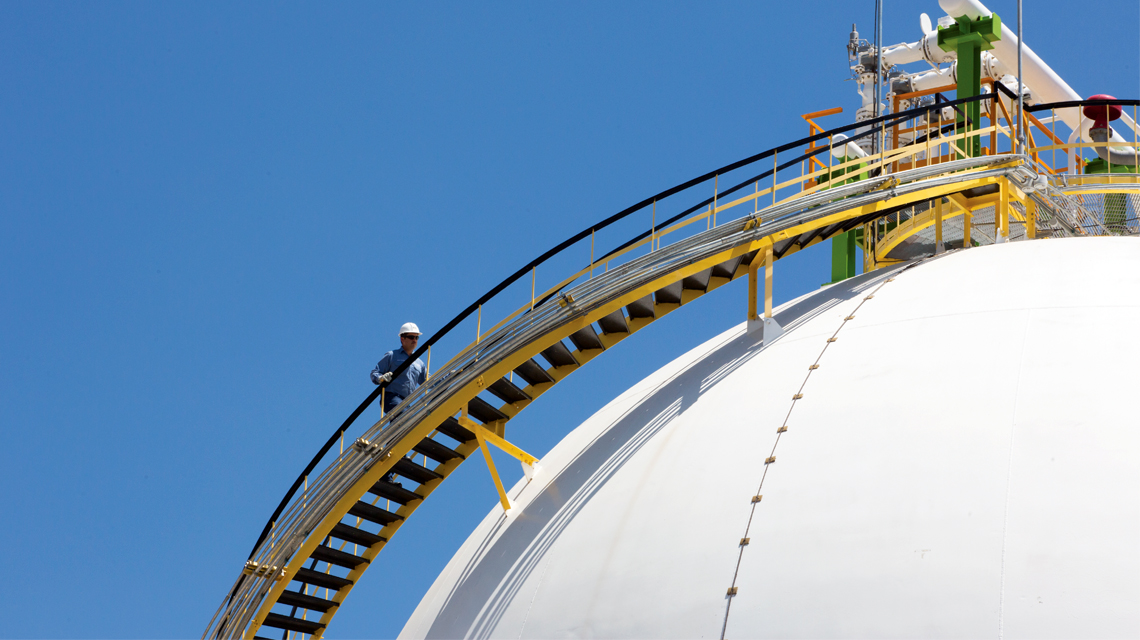 A team member inspects equipment at IEnova's liquid fuels storage facility