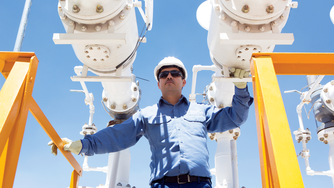 A Sempra Infrastructure team member stands in a project site