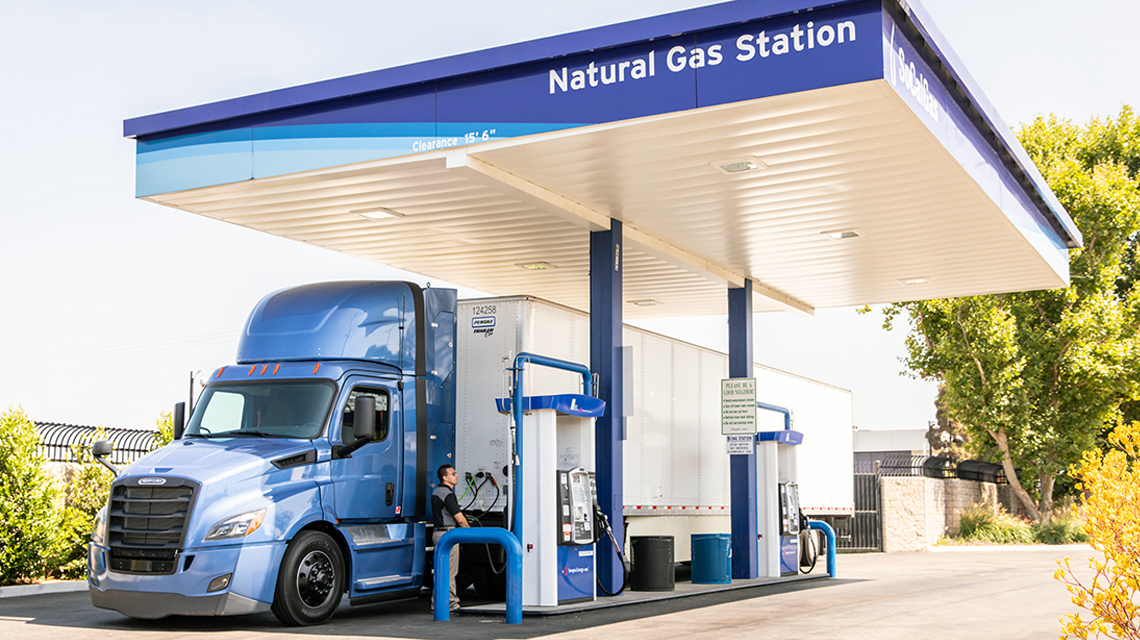 A driver fills the gas tank of a semi truck at one of SoCalGas' natural gas vehicle fueling stations