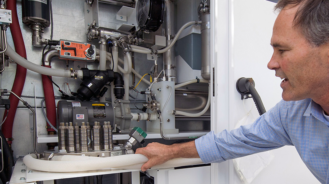 A team member demonstrates SoCalGas' power-to-gas project