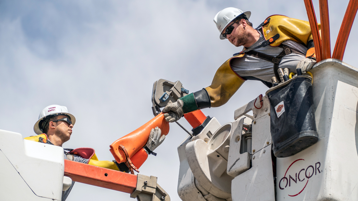 Oncor team members working on a transmission line