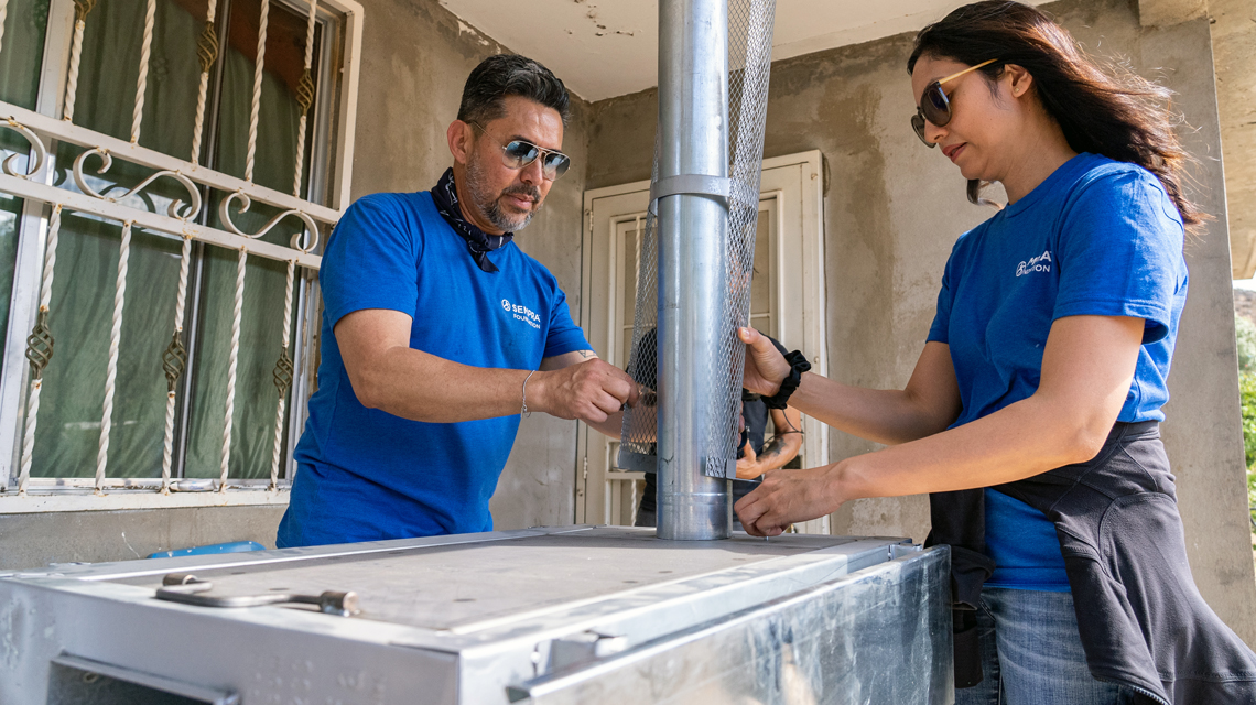 Sempra employees volunteer to assemble a clean-cooking stove for a family in Mexico