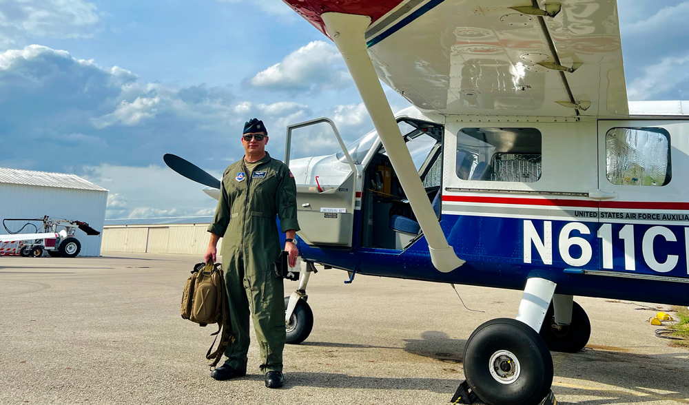 Harvey Wagner of Sempra Infrastructure, a volunteer captain with the Civil Air Patrol, poses in front of an airplane