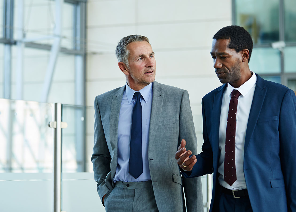Two men in suits having a discussion
