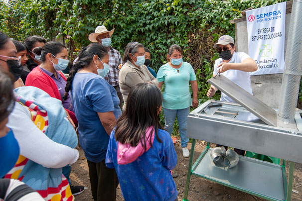 Community members in Mexico learn how their new, cleaner-burning stoves operate