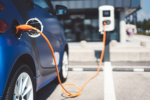 electric vehicle plugged into charging station