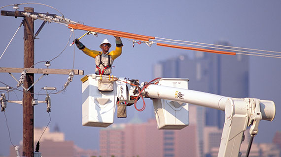 An Oncor team member working on a transmission line
