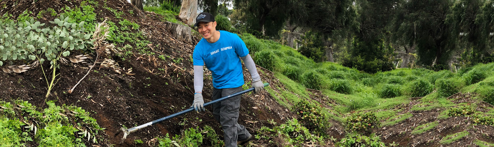 Volunteer helping at tree-planting event Volunteer helping at tree-planting event