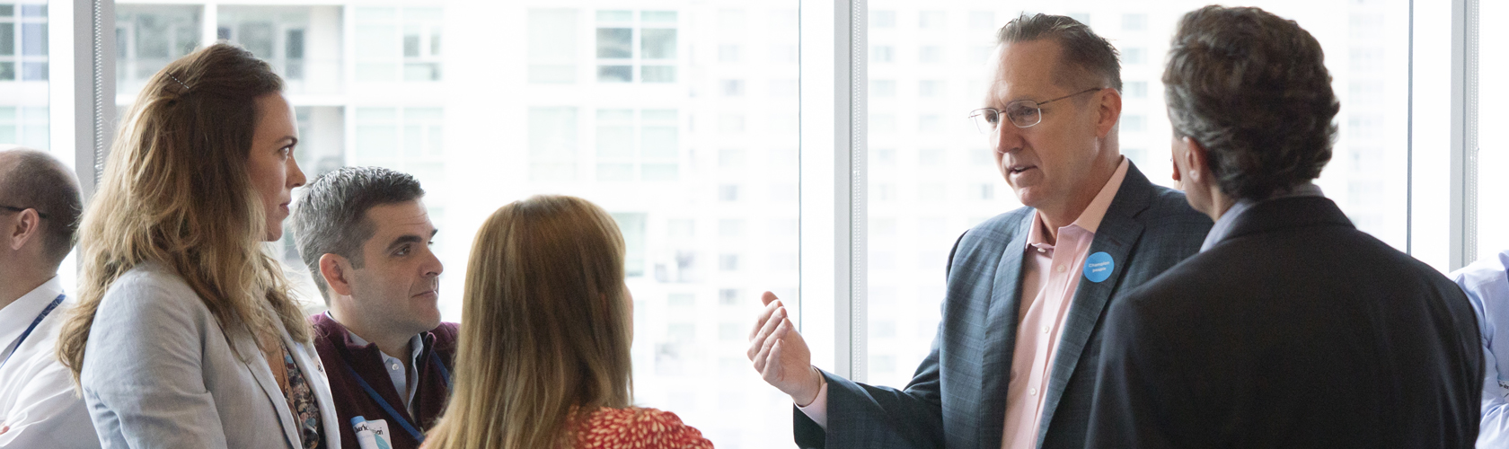 Employees chat with Jeffrey Martin during a recent breakfast event.