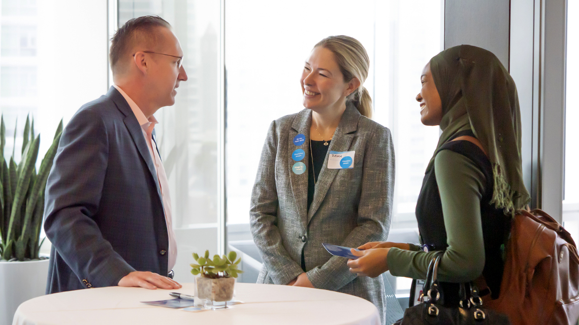 Employees chat with Jeffrey Martin during a recent breakfast event.