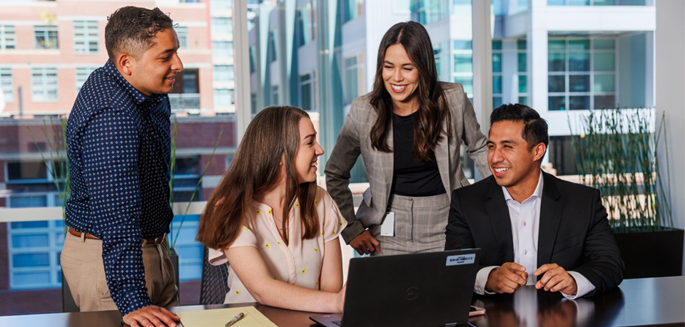 Team members work together at a desk